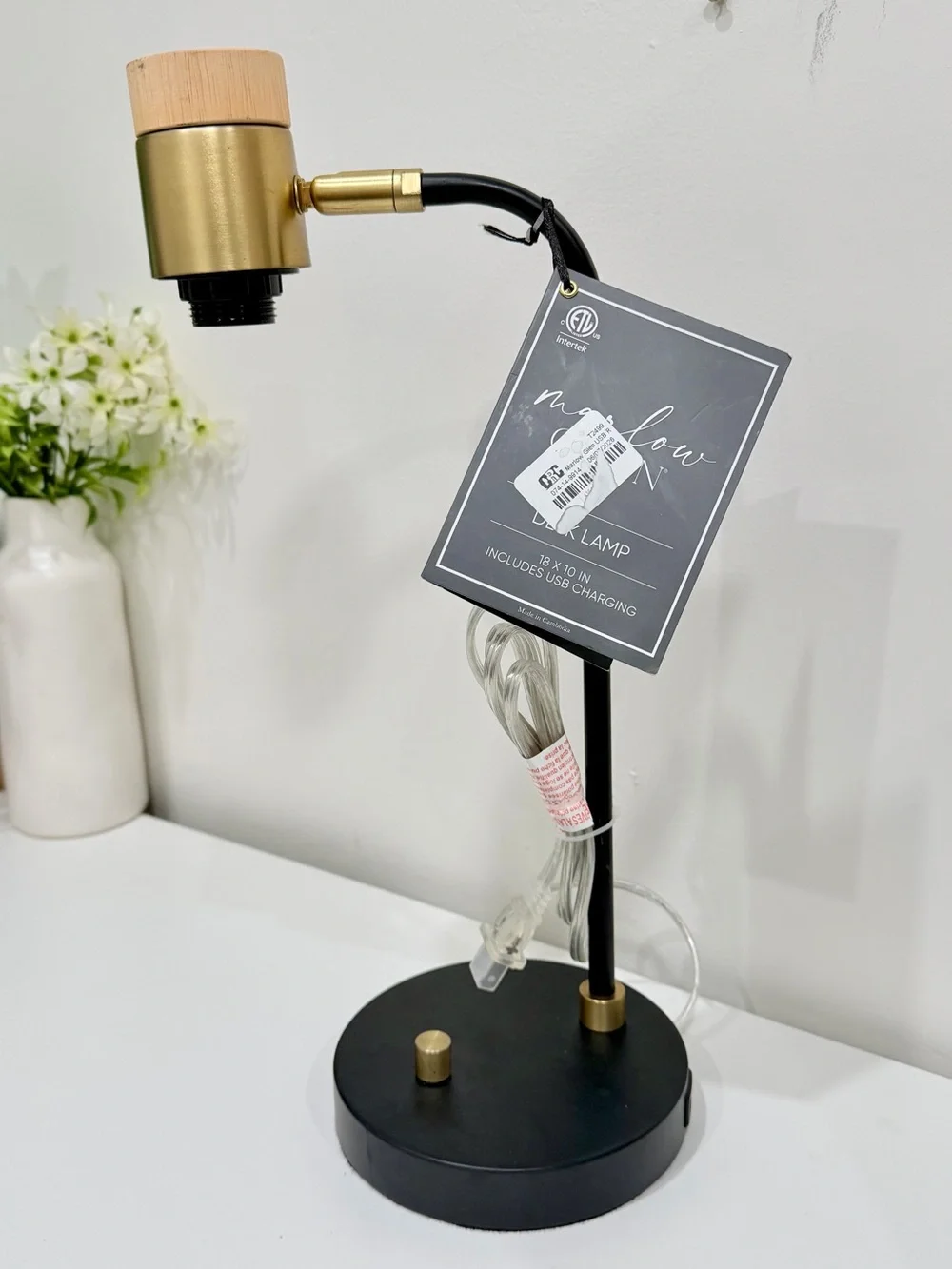 black and brass desk lamp with a small wooden accent piece on the socket